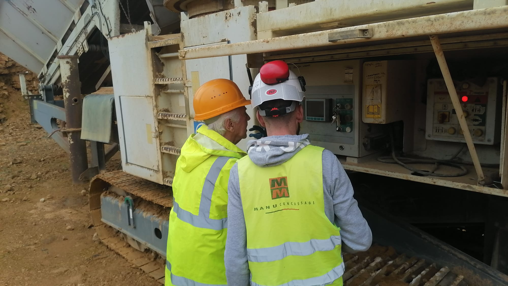 Workers at a control panel
