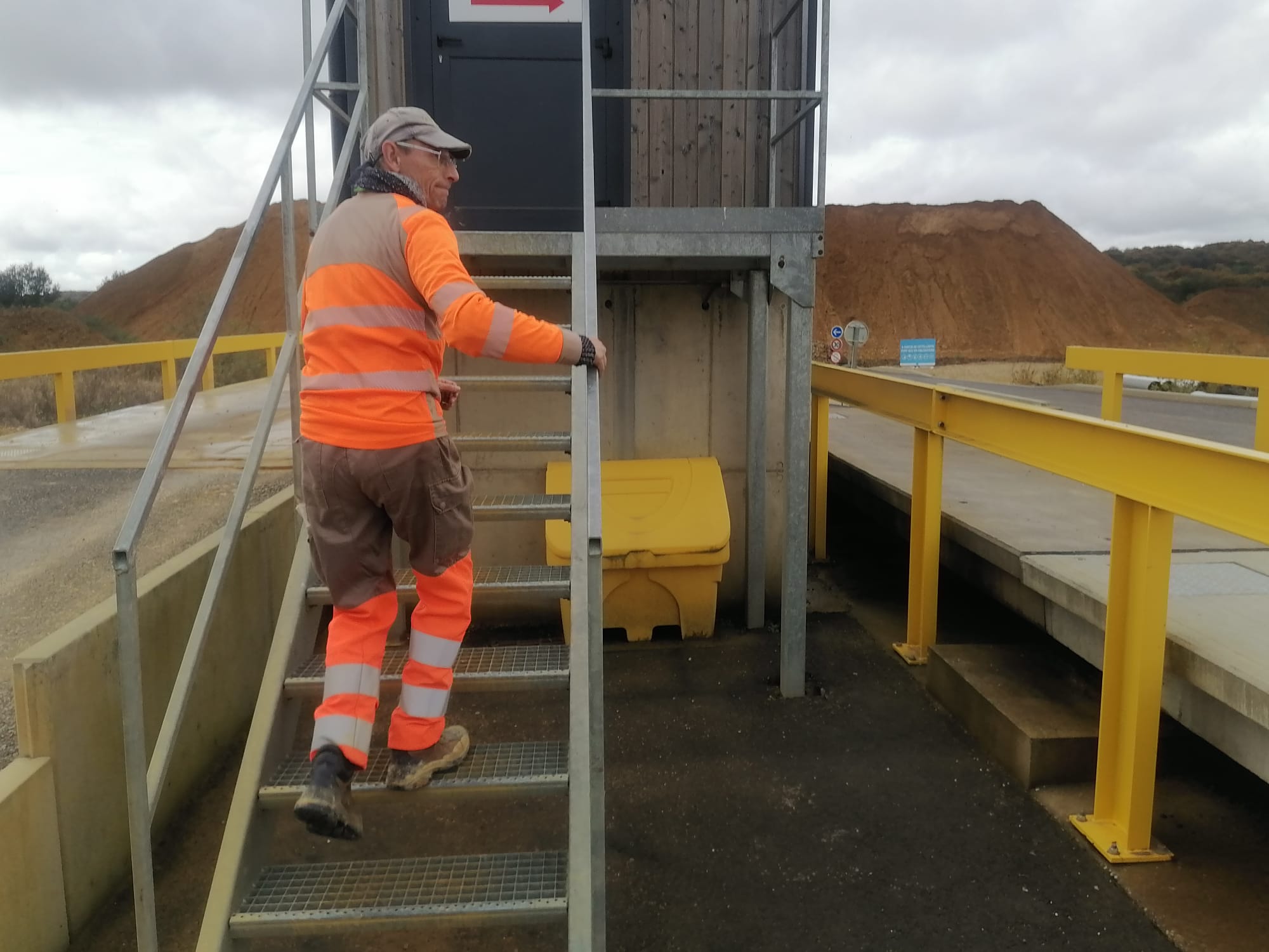 Worker on industrial stairs